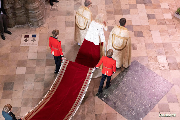 Queen Consort Camilla enters the Abbey through the Great West Door, in London, United Kingdom, May 6, 2023.   Jeff Gilbert/Pool…