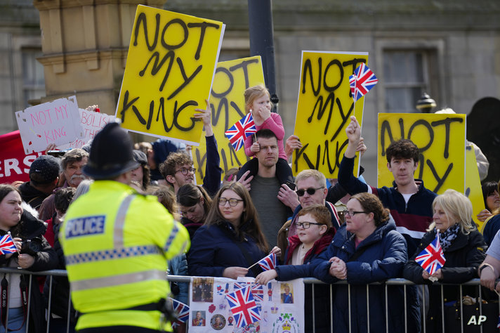 FILE - Protestors wait for the arrival of King Charles III and Camilla, the Queen Consort to visit Liverpool Central Library,…