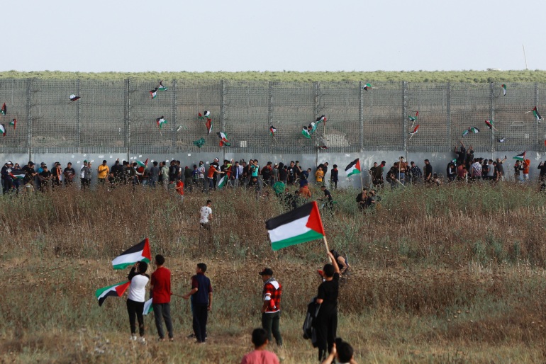 Palestinians take part in a protest against the holding of the annual flag march in Jerusalem which marks Jerusalem Day