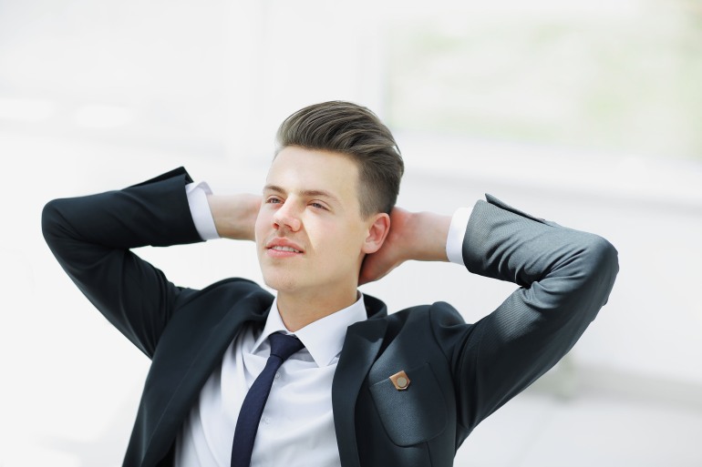 closeup.meditating businessman sitting behind a Desk. Relaxation techniques at workplace; Shutterstock ID 1327230653; purchase_order: aljazeera ; job: ; client: ; other: