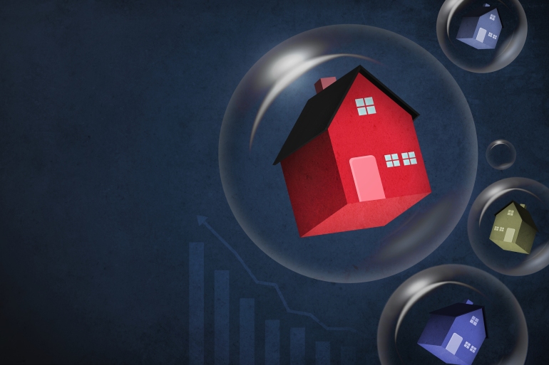 Set of houses inside bubbles showing a housing bubble in the horizon GettyImages-1414150214