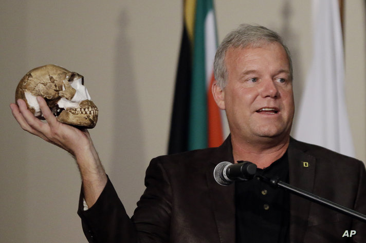 FILE - Researcher Lee Berger holds a reconstruction of the skull of Homo naledi at Magaliesburg, South Africa, Thursday, Sept…