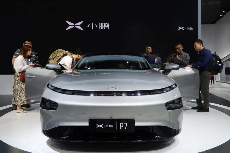 People look at XPeng's P7 sedan model displayed at the Guangzhou auto show in Guangzhou, Guangdong province, China November 22, 2019. Picture taken November 22, 2019. REUTERS/Yilei Sun