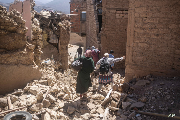 Residents flee their homes after an earthquake in Moulay Brahim village, near the epicenter of the earthquake, outside…