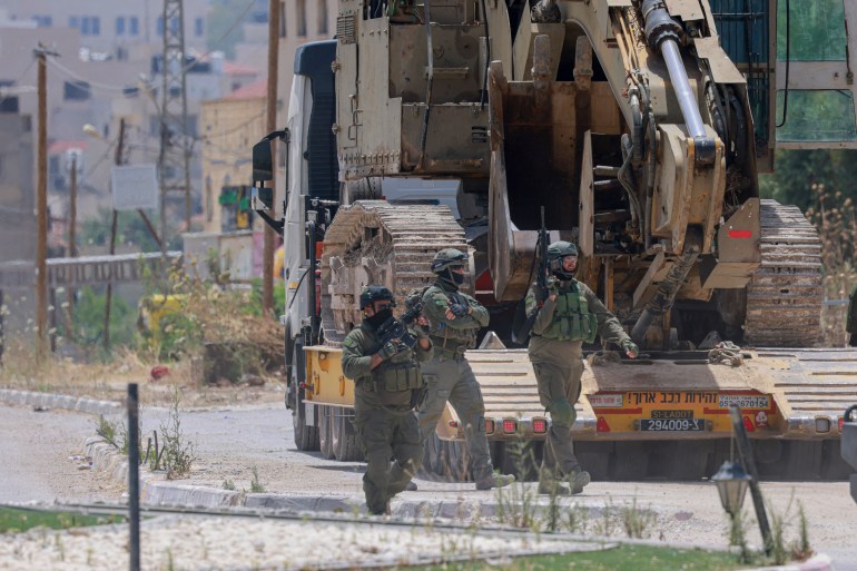 Israeli forces storm the Palestinian refugee camp of Jenin in the occupied West Bank on May 21, 2024, in what the military said was a "counterterrorism operation", without providing further details. - Palestinian health officials said seven Palestinians were killed in the raid on May 21, including a school student, a teacher and a surgeon from the Jenin government hospital. (Photo by Jaafar ASHTIYEH / AFP)