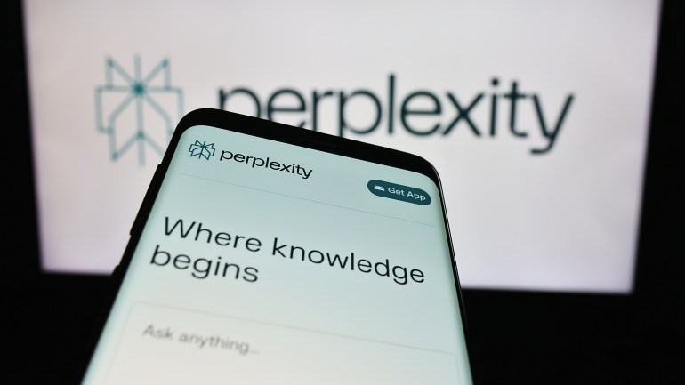 Stuttgart, Germany - 02-16-2024: Mobile phone with website of US artificial intelligence company Perplexity AI in front of business logo. Focus on top-left of phone display. Unmodified photo.