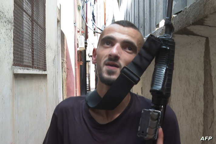 An image grab from AFP TV archive footage taken in July 2023 shows Muhammad Jabber, also known as Abu Shujaa, a commander in…