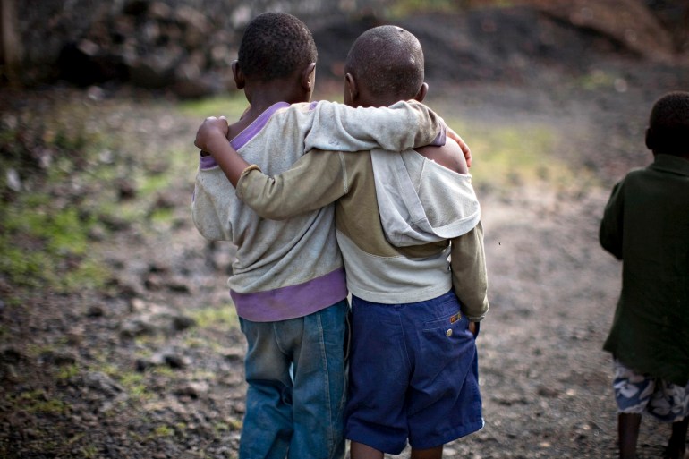 Boys displaced by war walk together at the Don Bosco center in Goma in eastern Congo, November 23, 2008. Fighting in eastern Congo has displaced hundreds of thousands of civilians in recent weeks, with 1,519 people sheltering in the Don Bosco school compound. REUTERS/Finbarr O'Reilly (DEMOCRATIC REPUBLIC OF CONGO)