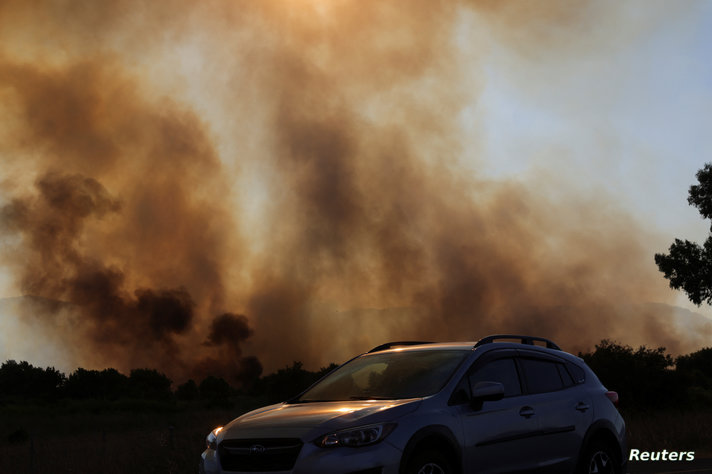 Smoke rises from a fire close to the area where, according to Israel's emergency services, a rocket was fired from Lebanon which killed a man when it landed in a kibbutz, in Horshat Tal