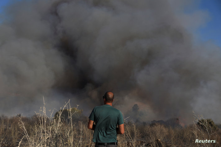 Smoke rises from a fire close to the area where, according to Israel's emergency services, a rocket was fired from Lebanon which killed a man when it landed in a kibbutz, in Horshat Tal