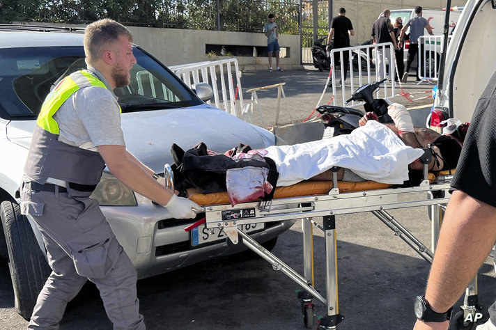 A Civil Defense first-responder carries a wounded man whose handheld pager exploded at al-Zahraa hospital in Beirut, Lebanon,…