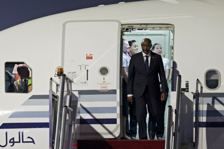 Sudan's army chief Abdel Fattah al-Burhan (L) arrives at Beijing Capital International Airport ahead of the Forum on China-Africa Cooperation (FOCAC) summit, in Beijing, on September 3, 2024. - (Photo by FLORENCE LO / POOL / AFP)