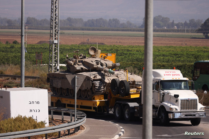 Israeli Army tanks are transported, in northern Israel