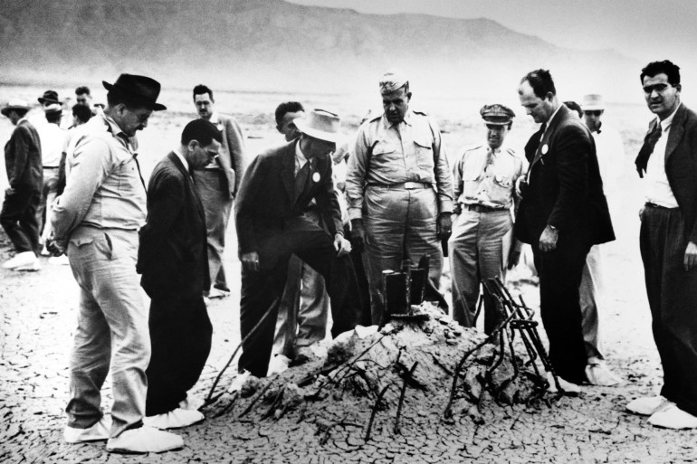 Groves and Oppenheimer Inspect Trinity Robert Oppenheimer and General Leslie Groves (center) examine the twisted wreckage that is all that remains of a hundred-foot tower, winch, and shack that held the first nuclear weapon. On the far right is Victor Weisskopf, of the Manhattan Project's Theoretical Division. | Location: Alamagordo, New Mexico, USA. (Photo by © CORBIS/Corbis via Getty Images)