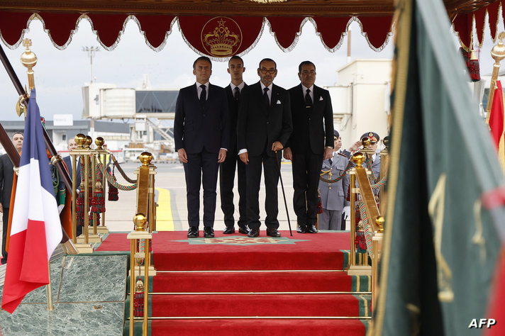 Morocco's King Mohammed VI (2nd-R) and France's President Emmanuel Macron (L) review the honour guard in the capital Rabat on…