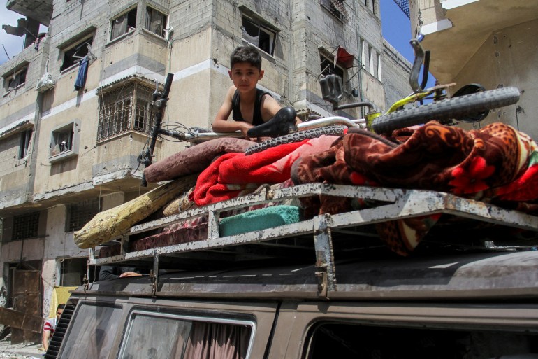 A Palestinian boy sits atop a vehicle loaded with belongings as he returns to his house at Zeitoun neighborhood after Israeli forces withdrew from the area following a raid, in Gaza City, May 15, 2024. REUTERS/Mahmoud Issa TPX IMAGES OF THE DAY