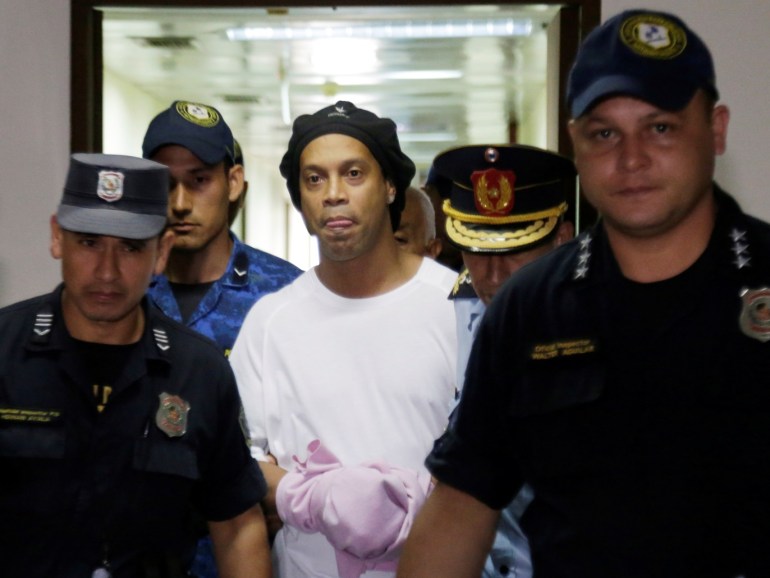 Judge rules Ronaldinho must remain in Paraguayan jail - Paraguayan Supreme Court, Asuncion, Paraguay - March 7, 2020? Ronaldinho handcuffed and escorted by police at the Supreme Court of Paraguay?REUTERS/Jorge Adorno