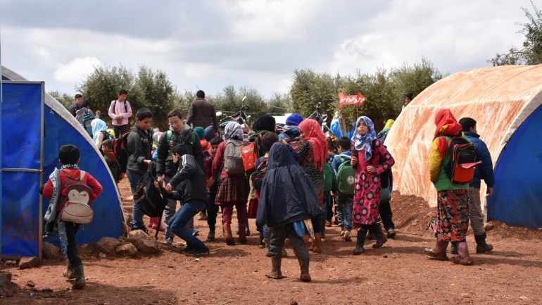 Syrian children hold on to education despite challenges- - AZAZ, SYRIA - APRIL 8: Students leave school after classes finish in the Shuhada Miskan refugee camp in Azaz region, Syria on April 8, 2019. As the conflict in Syria enters its ninth year, a generation born and raised in an environment of conflict continues to hold on to education despite tough conditions. While conflict, displacement and violence became part of the daily life in Syria, children hold steadfast to hope for a brighter future in the Shuhada Miskan school located in the Yazi Bagh refugee camp in Syria's northwestern Azaz region.