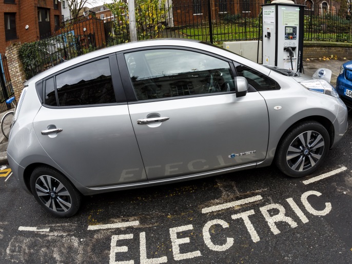 Go Ultra Low Nissan LEAF (L) and Kia Soul EV (R) on charge on a London street. Ultra-low emission vehicles such as this can cost as little as 2p per mile to run and some electric cars and vans have a range of up to 700 miles.