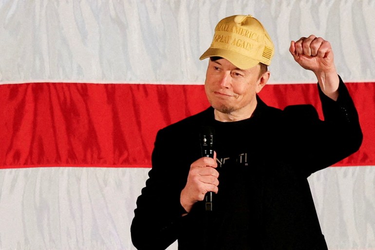 FILE PHOTO: Tesla CEO and X owner Elon Musk, who supports Republican presidential nominee Donald Trump, gestures as he speaks about voting during an America PAC Town Hall in Folsom, Pennsylvania, U.S., October 17, 2024. REUTERS/Rachel Wisniewski/File Photo