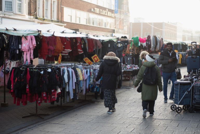 BARKING, LONDON- NOVEMBER 14: A general view of shoppers walking past a clothing stall in Barking Town Centre street market on November 14, 2022 in Barking, London. (Photo by John Keeble/Getty Images)