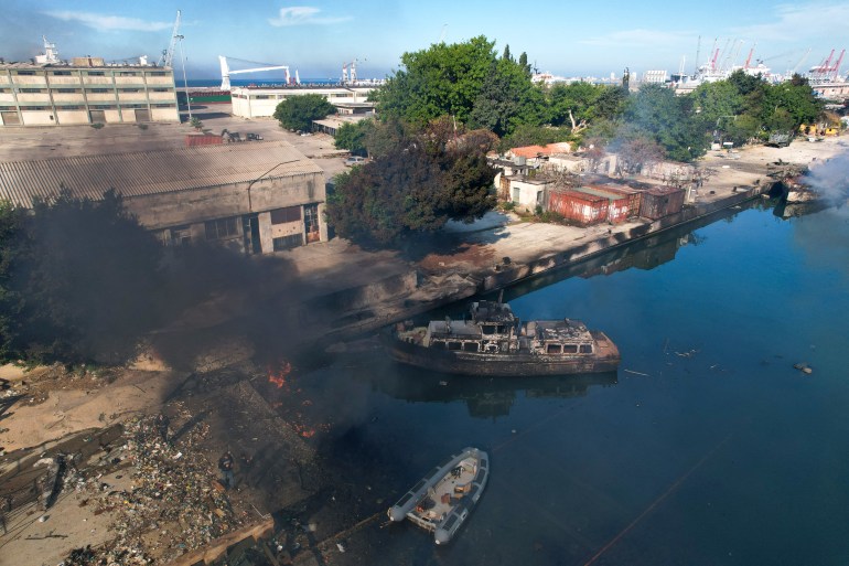 An aerial photo shows Syrian naval ships destroyed in an overnight Israeli attack on the port city of Latakia on December 10, 2024. - The UN special envoy for Syria on December 10 called on Israel to halt its military movements and bombardments inside Syria, days after the fall of president Bashar al-Assad. (Photo by AAREF WATAD / AFP)