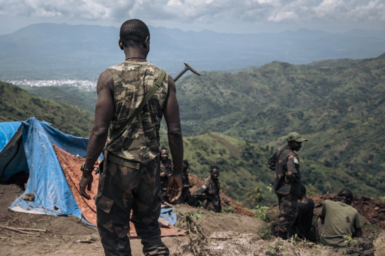 FARDC (Armed Forces of the DRC) soldiers dig trenches at a frontline military position above the town of Kibirizi, controlled by the M23 rebellion, North Kivu province, eastern Democratic Republic of Congo, on May 14, 2024. Since mid-May, fighting are raging in this area. The Congolese army, supported by hundreds of fighters from local armed groups, is attempting to reconquer areas under the control of the M23 rebels and Rwandan army (RDF) troops, where they have set up a parallel administration. Since late 2021, they have seized large swathes of North Kivu province and routed the Congolese army. The United States and France are urging Rwanda President Paul Kagame to withdraw his troops from Congolese soil, including the surface-to-air missile systems. (Photo by ALEXIS HUGUET / AFP)