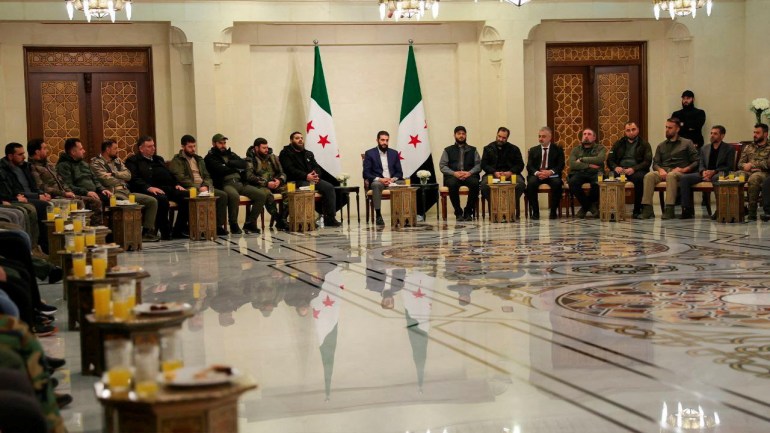 Syria's de facto leader Ahmed al-Sharaa attends a meeting with former rebel faction chiefs, as he reached an agreement with them to dissolve all groups and consolidate them under the Defence Ministry, according to a statement from the new administration, in Damascus, Syria, in this handout image released on December 24, 2024. SANA/Handout via REUTERS ATTENTION EDITORS - THIS IMAGE WAS PROVIDED BY A THIRD PARTY. REUTERS IS UNABLE TO INDEPENDENTLY VERIFY THIS IMAGE.