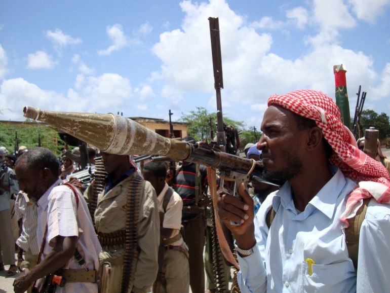 Somali men belonging to a local militia called the Islamist fighters from Hisb Al Islam march in the southern part of Mogadishu during a show of force event on March 23, 2009. Islamist fighters including the hardline Shebab militia have waged battles against the government and its allies since before the new President of Somalia Sharif Sheikh Ahmed was voted into power. Ahmed came to power, vowing to fight until all foreign forces withdraw and sharia law is imposed. Somalia has had no effective central authority since the 1991 ouster of former president Mohamed Siad Barre touched off a bloody cycle of clashes between rival factions. AFP PHOTO/Mustafa ABDI (Photo by MUSTAFA ABDI / AFP)