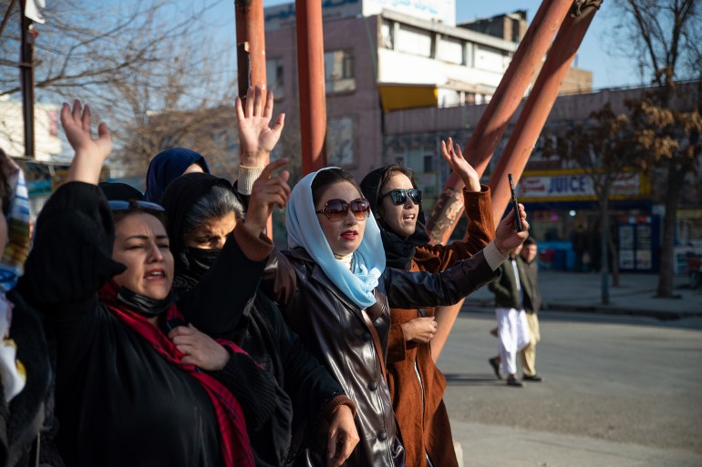 KABUL, AFGHANISTAN - DECEMBER 22: Afghan women protest against new Taliban ban on women accessing University Education on December 22, 2022 in Kabul, Afghanistan. A group of Afghan women rallied in Kabul against a governmental order banning women from universities. Armed guards barred women from accessing university sites since the suspension was announced on December 20. (Photo by Stringer/Getty Images)