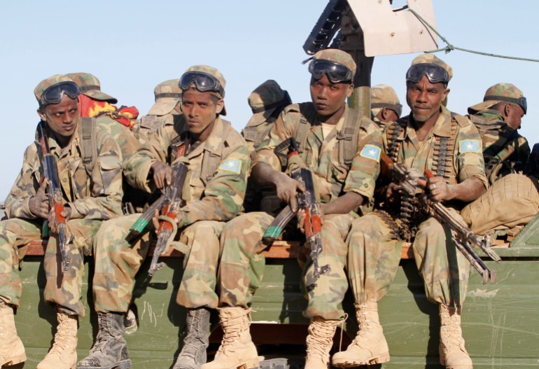 Somalia's army soldiers make their way to the town of Barawe during the second phase of Operation Indian Ocean October 4, 2014. Somalia's army and African troops deployed forces on Monday inside the strategic port which they retook from Islamist rebels at the weekend, promising residents they would be protected. The force of African Union peacekeepers and the Somali National Army said on Sunday they had driven out al Shabaab militants without a fight from Barawe, a stronghold used by rebels to ship in guns and generate cash from charcoal exports. Picture taken October 4, 2014 REUTERS/Feisal Omar (SOMALIA - Tags: MILITARY CIVIL UNREST POLITICS)