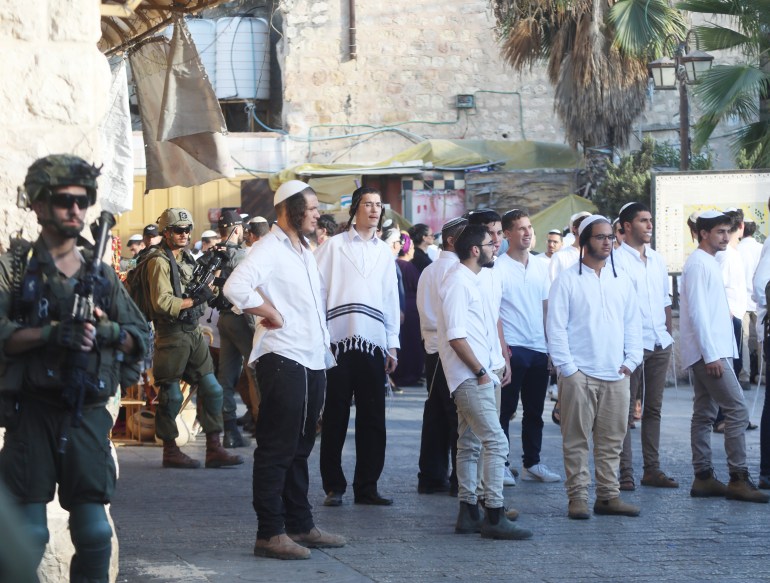 Jewish settlers under the protection of Israeli forces raid Hebron- - HEBRON, WEST BANK - SEPTEMBER 14: A group of Jewish settlers under the protection of Israeli soldiers raids the Old City area of Hebron, West Bank on September 14, 2024.