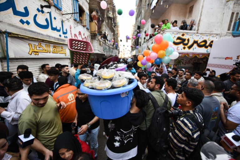 CAIRO, EGYPT - MARCH 15: Egyptians gather for a communal iftar, the fast-breaking evening meal during the holy month of Ramadan, in Ezbet Hamada in the Matariya suburb on March 15, 2025 in Cairo, Egypt. During the Islamic month of Ramadan, Muslims break their daily fast with an Iftar meal at sunset. (Photo by Sayed Hassan/Getty Images)