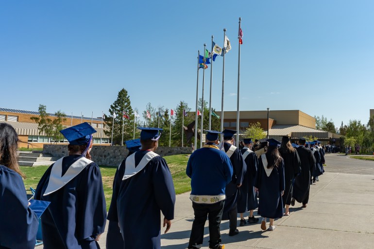 Whitehorse, Yukon Territory, Canada - June 4, 2022: Class of 2022 graduates of Yukon University are in an orderly line to enter the in-person graduation ceremony venue