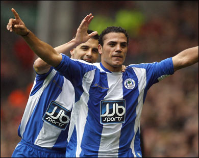 f/(FILES) This file picture taken on October 18, 2008 in Liverpool shows Wigan Athletic's Egyptian forward Amr Zaki (R) being congratulated by Wigan Athletic's Austrian midfielder Paul Scharner after scoring against Liverpool during their English Premier League football match at Anfield.