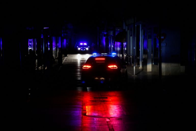 Police car patrols a shopping street without electric lighting to prevent theft and looting in the stores during a power outage which hit large parts of Spain, in Ronda, Spain April 28, 2025. REUTERS/Jon Nazca