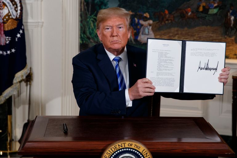 FILE - U.S. President Donald Trump shows a signed Presidential Memorandum after delivering a statement on the Iran nuclear deal from the Diplomatic Reception Room of the White House, on May 8, 2018. Iran will elect a new president Friday, June 28, 2024, after the death of hard-line President Ebrahim Raisi. Whoever takes the helm in the country will inherit Iran's rapidly advancing nuclear program, which now enriches uranium closer than ever to weapons-grade levels. (AP Photo/Evan Vucci, File)