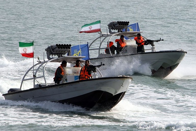 Iranian Revolutionary Guards drive speedboats during a ceremony to commemorate the 24th anniversary of the downing of Iran Air flight 655 by the US navy, at the port of Bandar Abbas on July 2, 2012. The plane was shot down by mistake over the Gulf by the US navy's guided missile cruiser, USS Vincennes, during confrontation with Iranian speedboats on July 3, 1988, killing 290 civilian passengers and crew members. AFP PHOTO/ATTA KENARE (Photo by ATTA KENARE / AFP)