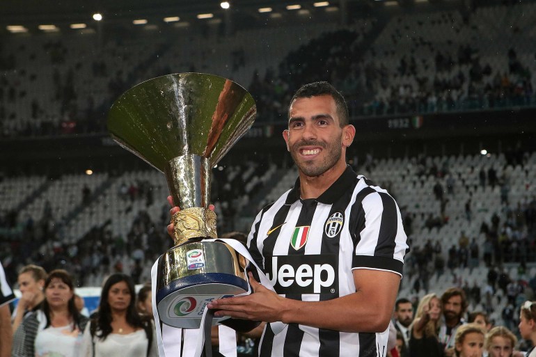 Juventus striker Carlos Tevez celebrates winning Serie A with the scudetto trophy (Photo by AMA/Corbis via Getty Images)