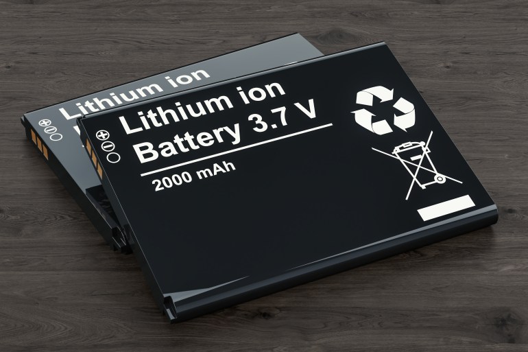 Battery or accumulator for phone on the wooden table, 3D rendering