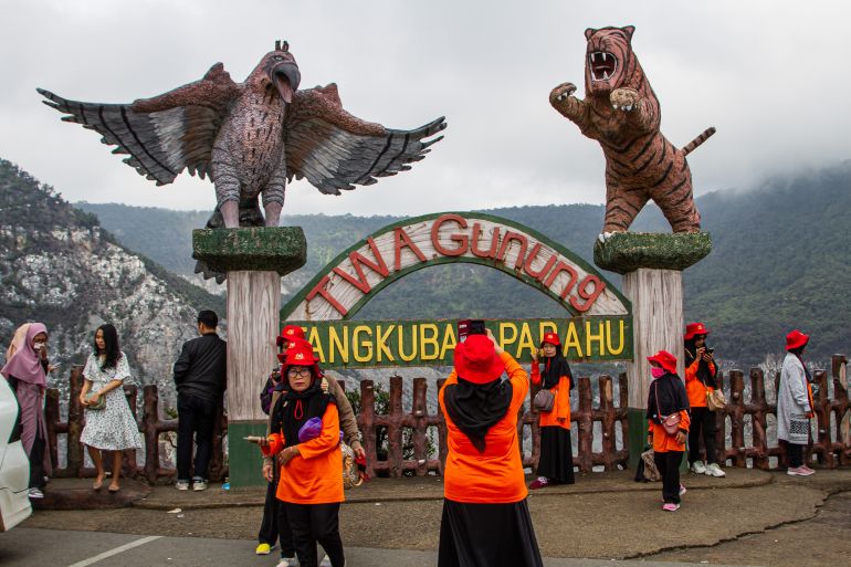 Bandung, Indonesia - November 5, 2023: People take a photo and enjoy the view crater of Tangkuban Perahu volcano in Bandung.