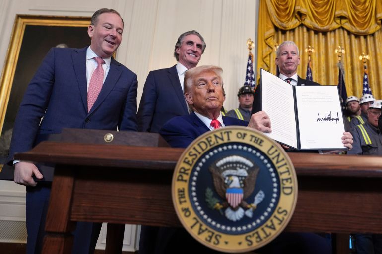 FILE - President Donald Trump holds a signed an executive order during an event in the East Room of the White House, April 8, 2025, in Washington, as from left Environmental Protection Agency director Lee Zeldin, Interior Secretary Doug Burgum and Energy Secretary Chris Wright watch. (AP Photo/Evan Vucci, File)
