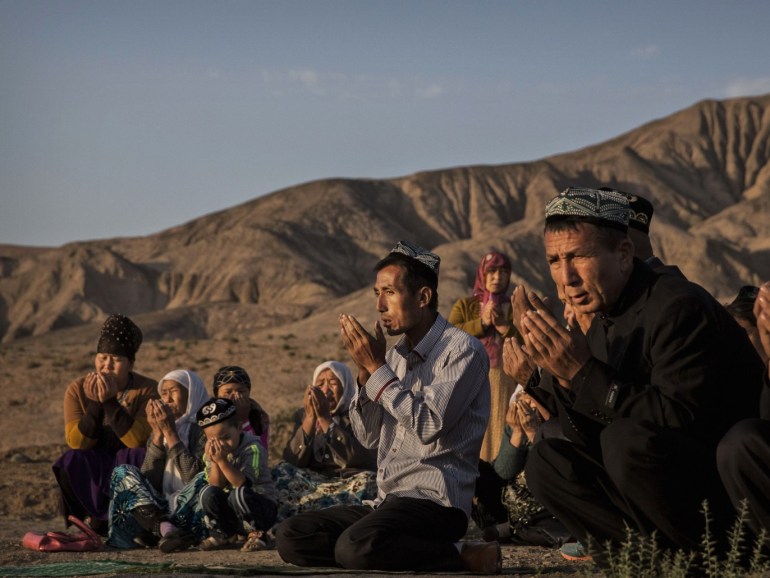 TURPAN, CHINA - SEPTEMBER 12: (CHINA OUT) A Uyghur family pray at the grave of a loved one on the morning of the Corban Festival on September 12, 2016 at a local shrine and cemetery in Turpan County, in the far western Xinjiang province, China. The Corban festival, known to Muslims worldwide as Eid al-Adha or 'feast of the sacrifice', is celebrated by ethnic Uyghurs across Xinjiang, the far-western region of China bordering Central Asia that is home to roughly half of the country's 23 million Muslims. The festival, considered the most important of the year, involves religious rites and visits to the graves of relatives, as well as sharing meals with family. Although Islam is a 'recognized' religion in the constitution of officially atheist China, ethnic Uyghurs are subjected to restrictions on religious and cultural practices that are imposed by China's Communist Party. Ethnic tensions have fueled violence that Chinese authorities point to as justification for the restrictions. (Photo by Kevin Frayer/Getty Images)