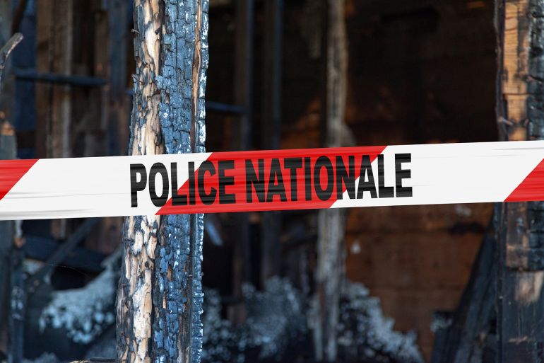 House burnt to the ground by a pyromaniac with a police tape with written in it in French "Police Nationale". - المصدر: أدوبي ستوك