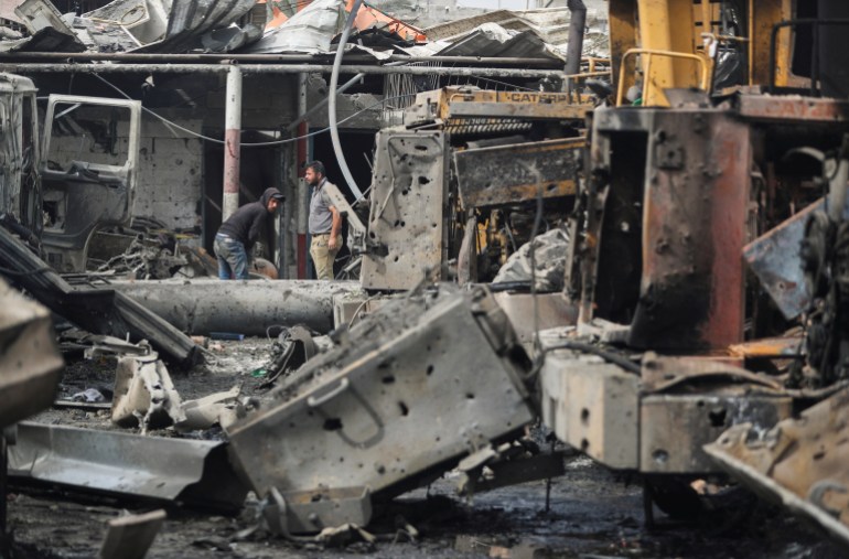 Palestinians inspect the site of an Israeli strike that hit machinery, in Jabalia refugee camp in the northern Gaza Strip, April 22, 2025. REUTERS/Mahmoud Issa