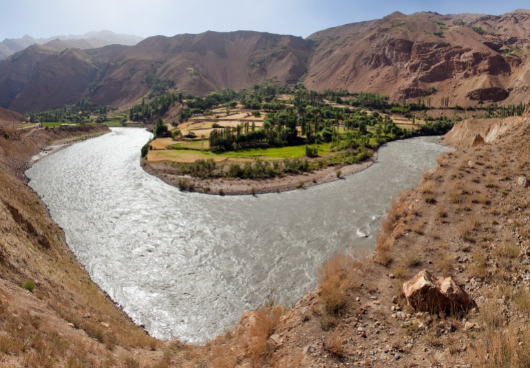 Panj river and Pamir mountains. Panj is upper part of Amu Darya river. Panoramic view.Tajikistan and Afghanistan border. Pamir highway