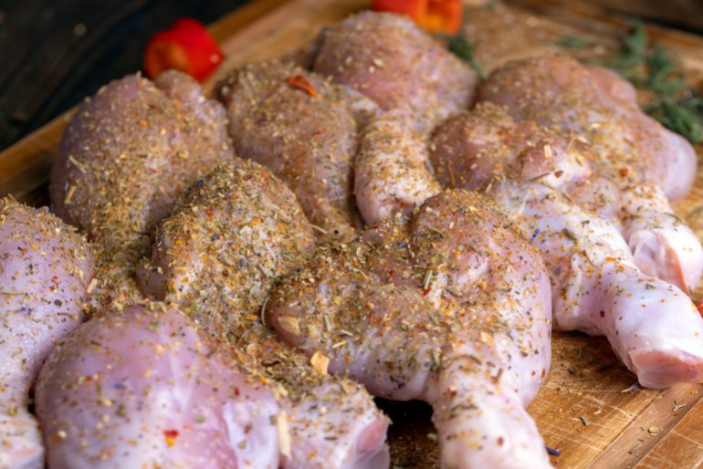 Freshly washed and skinned chicken meat, chicken legs with salt and spices ready for cooking