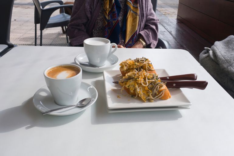 cups of coffee latte accompanied by a skewer of bread with eels; Shutterstock ID 2391921951; purchase_order: ds; job: d; client: d; other: d