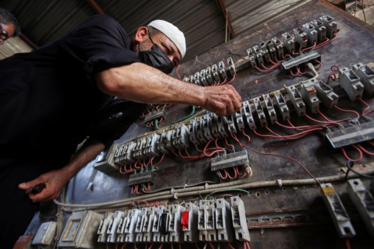 A man works on an electrical generator board during power outages in Basra, Iraq August 21, 2021. Picture taken August 21, 2021. REUTERS/Essam al-Sudani