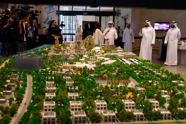 A model of the proposed development deal is displayed ahead of the signing ceremony between the Trump Organization and Qatar's Diar and Dar Global in Doha on April 30, 2025. The Trump Organization signed on April 30, its first development deal in Qatar to build a golf course and residential villas near the capital Doha, real estate firm Qatari Diar said. The 18-hole Trump International Golf Course and Trump Villas are to be constructed as part of a major government-backed development scheme unveiled last year, the Simaisma Project, which will also include a theme park and a marina. (Photo by Karim JAAFAR / AFP)